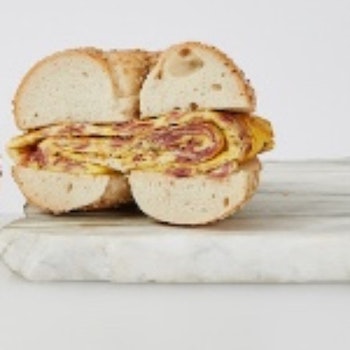 Photo of NY Deli-Style Corned Beef Omelette on a Bagel Sandwich