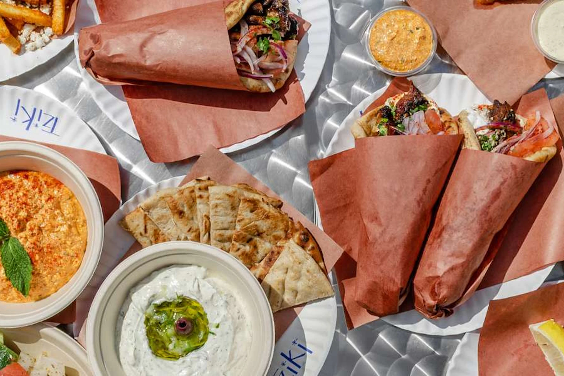 Tziki Corporate Catering and Group Ordering located at 209 7th Ave, New York, NY 10011, USA. Tziki's top menu items include Beef Kebab Greek Pita, Chicken Breast Skewer Greek Pita, Horiatiki Greek Salad.